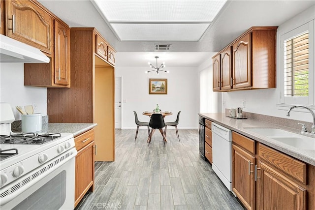 22331 Ramona Ave, Apple Valley, CA 92307 - kitchen featuring white appliances, a sink, a chandelier, brown cabinets, and light wood-type flooring