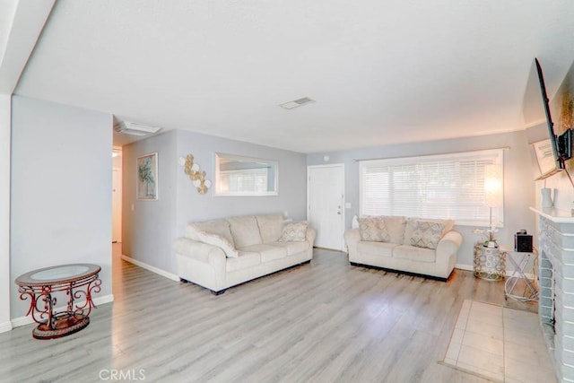 17152 Schollview Ave, Palmdale, CA 93591 - living room with wood finished floors, baseboards, and a fireplace