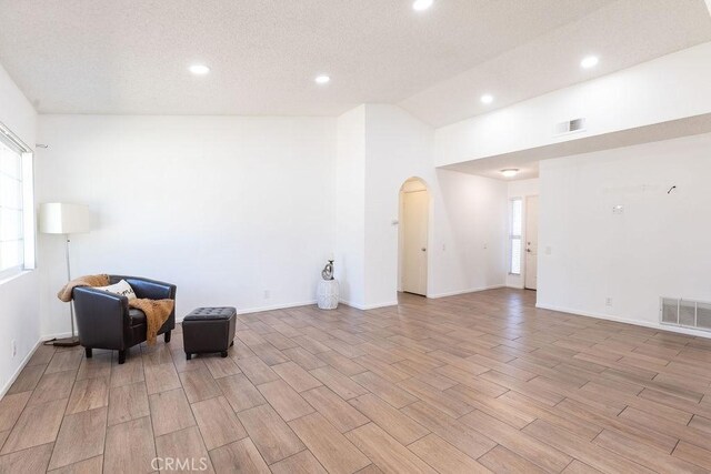42117 Agena St, Temecula, CA 92592 - unfurnished room featuring arched walkways, healthy amount of natural light, light wood-style floors, recessed lighting, and vaulted ceiling