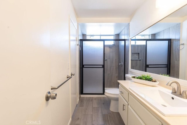 42117 Agena St, Temecula, CA 92592 - full bath featuring toilet, vanity, a shower stall, and wood finished floors