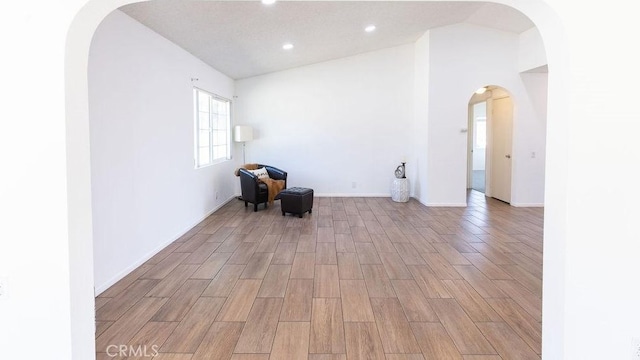 42117 Agena St, Temecula, CA 92592 - unfurnished room with arched walkways, light wood-style floors, recessed lighting, and baseboards