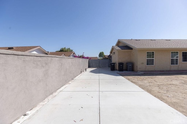 42117 Agena St, Temecula, CA 92592 - view of home's exterior with stucco siding, concrete driveway, and a patio area