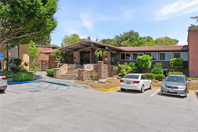 1105 Sepulveda Blvd # C101, Torrance, CA 90502 - view of front facade with a tile roof and uncovered parking