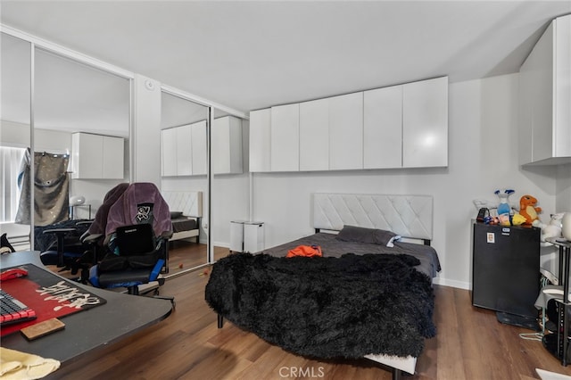 1105 Sepulveda Blvd # C101, Torrance, CA 90502 - bedroom with wood finished floors, a closet, and baseboards