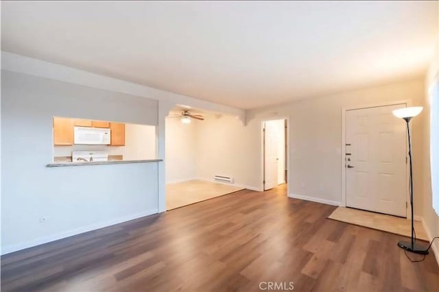1105 Sepulveda Blvd # C101, Torrance, CA 90502 - unfurnished living room with wood finished floors, a ceiling fan, and baseboards