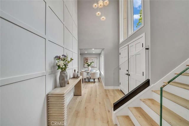 10 Lassen, Irvine, CA 92612 - entrance foyer with stairs, a towering ceiling, healthy amount of natural light, light wood-style floors, and baseboards