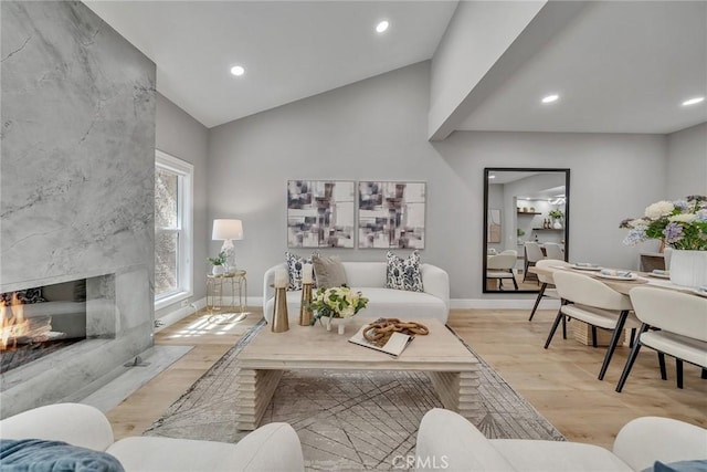 10 Lassen, Irvine, CA 92612 - living room featuring light wood-type flooring, baseboards, recessed lighting, a fireplace, and high vaulted ceiling
