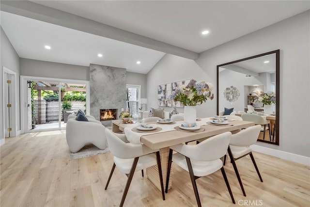 10 Lassen, Irvine, CA 92612 - dining space featuring lofted ceiling, light wood-style floors, healthy amount of natural light, a premium fireplace, and recessed lighting