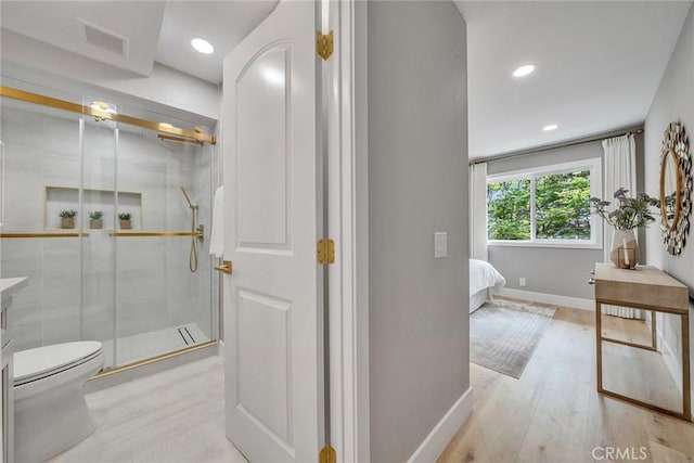 10 Lassen, Irvine, CA 92612 - bathroom featuring toilet, a stall shower, baseboards, wood finished floors, and recessed lighting