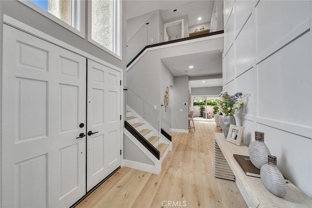 10 Lassen, Irvine, CA 92612 - foyer entrance with stairway, light wood-style floors, a high ceiling, and baseboards