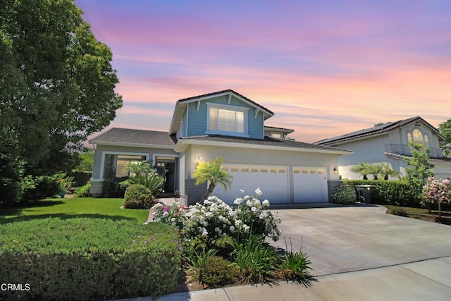904 Calle Higuera, Camarillo, CA 93010 - traditional-style house with concrete driveway, a front lawn, an attached garage, and stucco siding