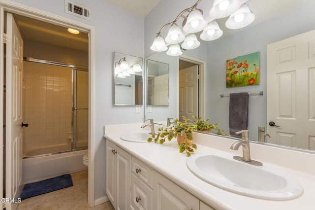 904 Calle Higuera, Camarillo, CA 93010 - bathroom with double vanity, bath / shower combo with glass door, toilet, tile patterned flooring, and a chandelier