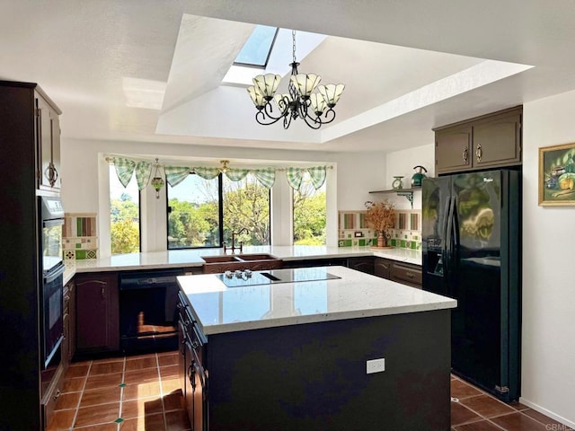 1650 Winterwarm Dr, Fallbrook, CA 92028 - kitchen with black appliances, a chandelier, dark tile patterned floors, a sink, and a peninsula
