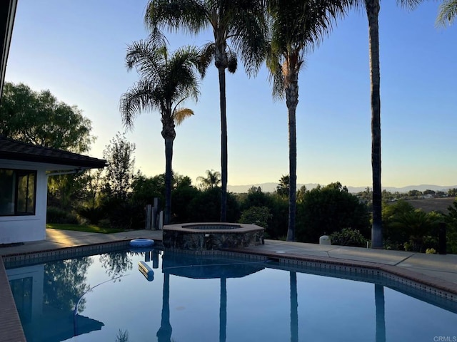 1650 Winterwarm Dr, Fallbrook, CA 92028 - pool at dusk featuring a pool with connected hot tub