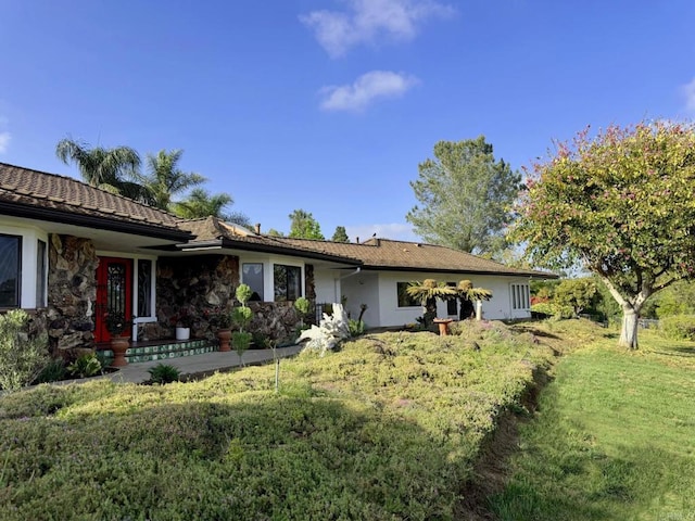 1650 Winterwarm Dr, Fallbrook, CA 92028 - view of front of property with a front lawn, a tiled roof, stucco siding, and stone siding