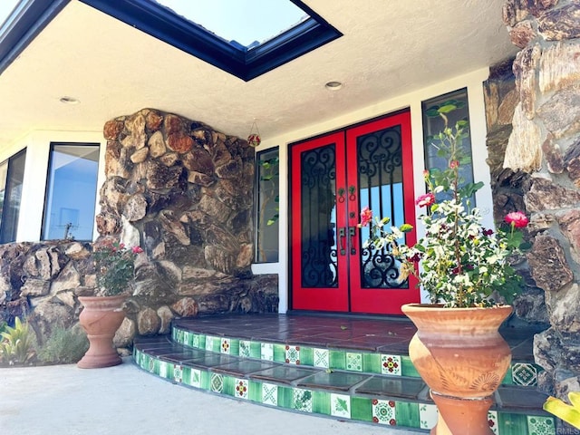 1650 Winterwarm Dr, Fallbrook, CA 92028 - entrance to property with french doors, stone siding, and a porch