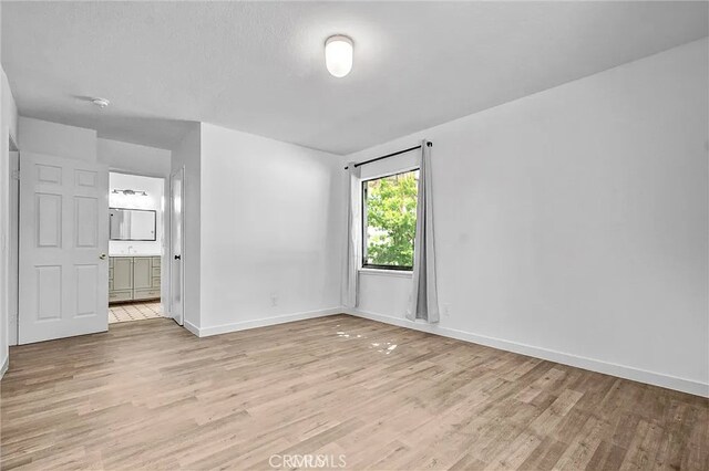 700 W 3rd St Unit A117, Santa Ana, CA 92701 - unfurnished room featuring light wood finished floors and baseboards