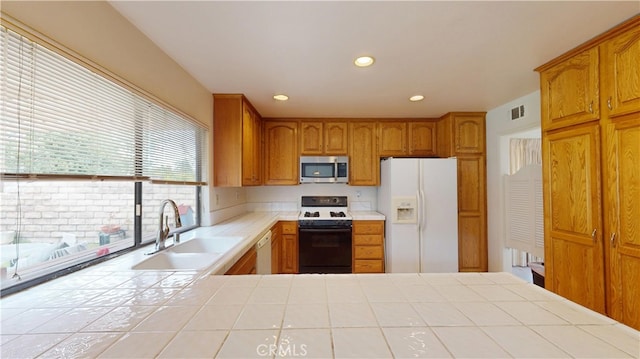 205 Cedar Heights Dr, Thousand Oaks, CA 91360 - kitchen featuring white appliances, a sink, tile counters, brown cabinetry, and recessed lighting