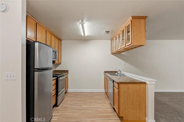 1114 Nord Ave Unit 36, Chico, CA 95926 - kitchen featuring appliances with stainless steel finishes, a sink, glass insert cabinets, and baseboards