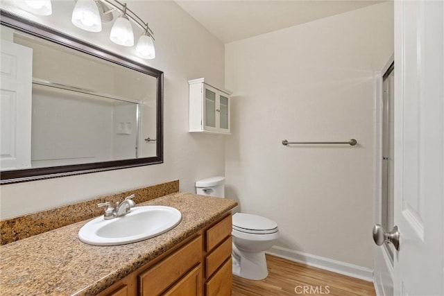 1114 Nord Ave Unit 36, Chico, CA 95926 - full bath with wood finished floors, vanity, baseboards, toilet, and a shower