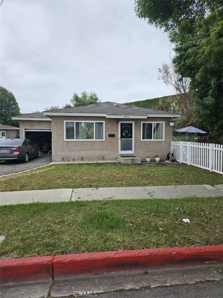3960 W 171st St, Torrance, CA 90504 - view of front facade with stucco siding, a garage, and roof with shingles