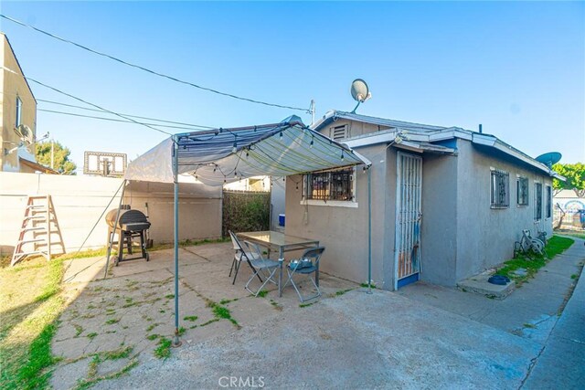 151 E 105th St, Los Angeles, CA 90003 - back of house featuring a patio area, a fenced backyard, and stucco siding
