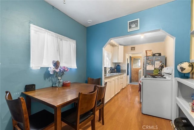 151 E 105th St, Los Angeles, CA 90003 - dining space featuring light wood finished floors and arched walkways