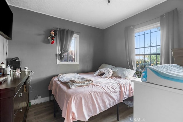 151 E 105th St, Los Angeles, CA 90003 - bedroom featuring wood finished floors and a textured ceiling