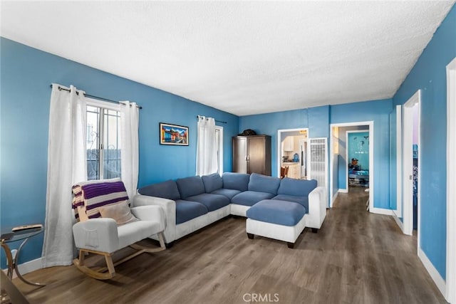 151 E 105th St, Los Angeles, CA 90003 - living area featuring a textured ceiling, baseboards, and wood finished floors