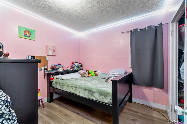 151 E 105th St, Los Angeles, CA 90003 - bedroom with wood finished floors and a textured ceiling