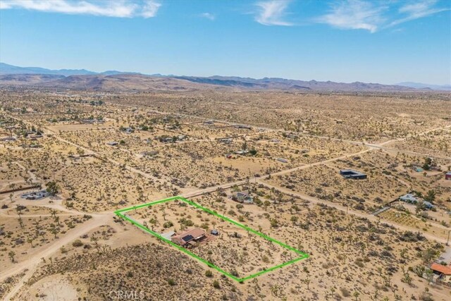 5115 Warren Vista Ave, Yucca Valley, CA 92284 - aerial view of sparsely populated area featuring a desert landscape, mountains, and property boundaries highlighted