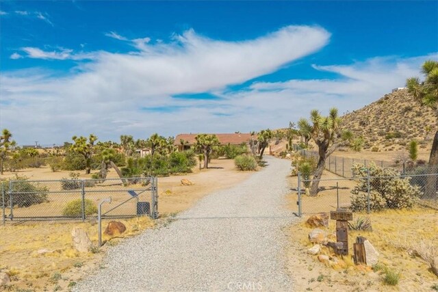 5115 Warren Vista Ave, Yucca Valley, CA 92284 - view of dirt / gravel road featuring a gated entry