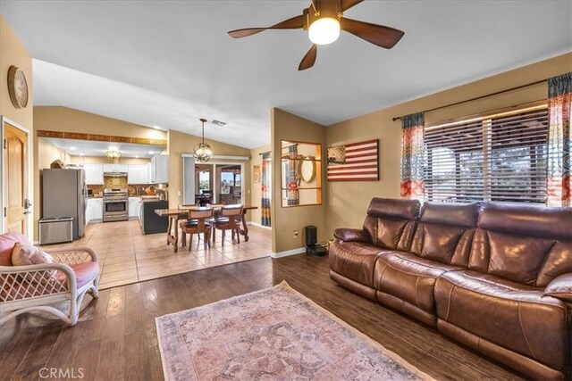 5115 Warren Vista Ave, Yucca Valley, CA 92284 - living area with vaulted ceiling, ceiling fan, light wood-style floors, and baseboards