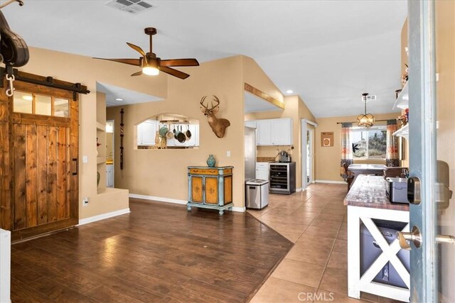 5115 Warren Vista Ave, Yucca Valley, CA 92284 - living room featuring wine cooler, lofted ceiling, a ceiling fan, baseboards, and wood finished floors