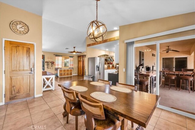 5115 Warren Vista Ave, Yucca Valley, CA 92284 - dining space featuring ceiling fan, light tile patterned flooring, a chandelier, baseboards, and lofted ceiling