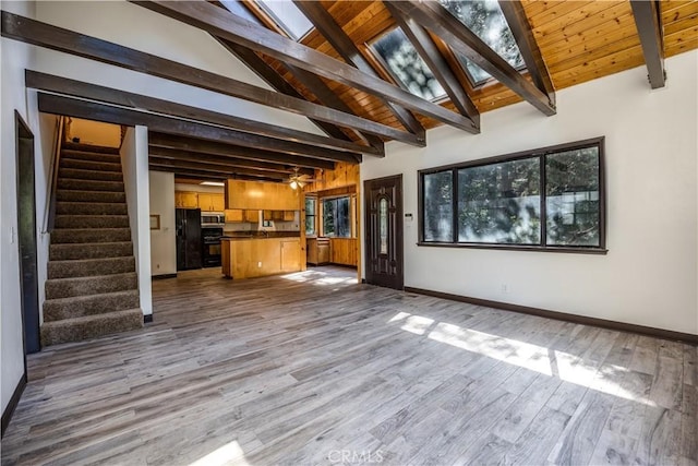 968 Lausanne Dr, Crestline, CA 92325 - unfurnished living room with stairway, wood finished floors, and baseboards