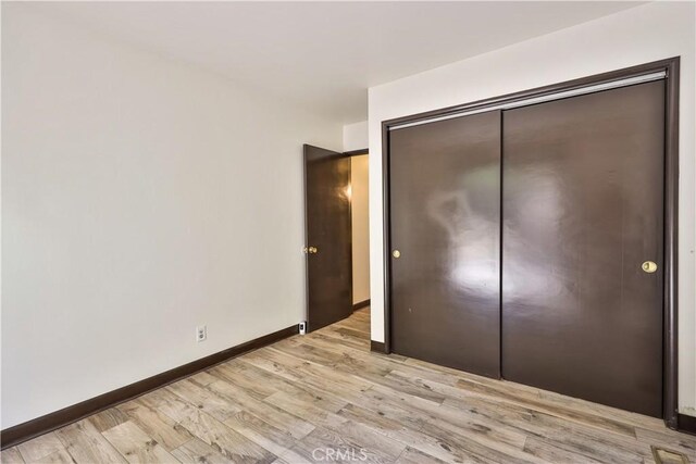 968 Lausanne Dr, Crestline, CA 92325 - unfurnished bedroom with light wood finished floors, a closet, and baseboards