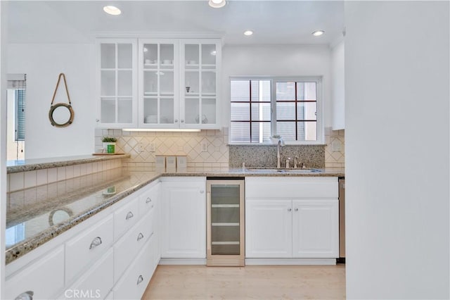 1713 Carlson, Redondo Beach, CA 90278 - kitchen featuring beverage cooler, light stone counters, glass insert cabinets, tasteful backsplash, and recessed lighting