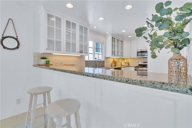 1713 Carlson, Redondo Beach, CA 90278 - kitchen featuring stainless steel appliances, light stone countertops, white cabinets, glass insert cabinets, and recessed lighting