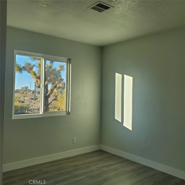 58922 Sunway Dr, Yucca Valley, CA 92284 - spare room with dark wood finished floors, a textured ceiling, and baseboards