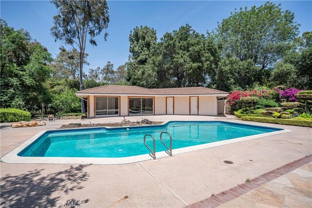 20827 E Mesarica Rd, Covina, CA 91724 - outdoor pool featuring a patio and view of scattered trees