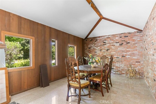 20827 E Mesarica Rd, Covina, CA 91724 - dining room featuring healthy amount of natural light, lofted ceiling, brick wall, and wooden walls