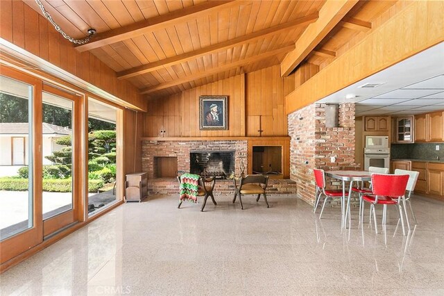 20827 E Mesarica Rd, Covina, CA 91724 - living area featuring a brick fireplace, wood walls, and wooden ceiling