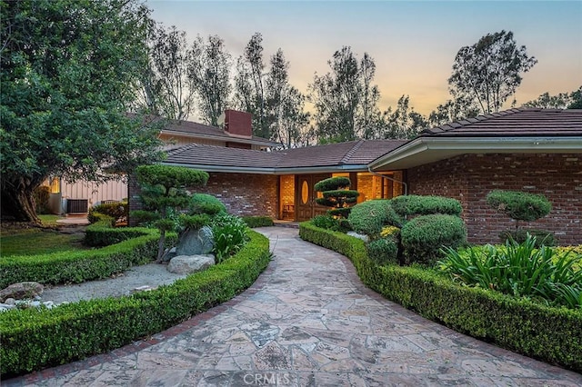 20827 E Mesarica Rd, Covina, CA 91724 - view of front of property with brick siding, a tiled roof, and a chimney