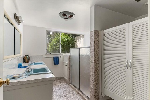 20827 E Mesarica Rd, Covina, CA 91724 - bathroom with a closet, a stall shower, double vanity, and speckle patterned floor