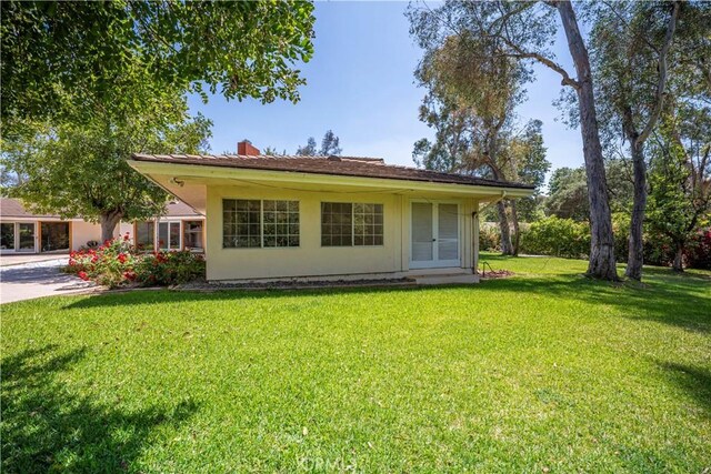 20827 E Mesarica Rd, Covina, CA 91724 - back of property featuring a yard and a chimney