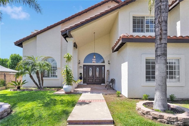 1048 Gladstone St, La Verne, CA 91750 - property entrance featuring a tile roof, a yard, and stucco siding