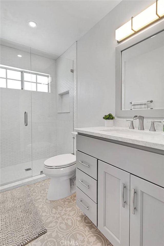 1048 Gladstone St, La Verne, CA 91750 - bathroom featuring vanity, toilet, a shower stall, recessed lighting, and tile patterned flooring