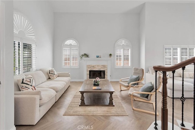 1048 Gladstone St, La Verne, CA 91750 - living room with a towering ceiling, a glass covered fireplace, and baseboards