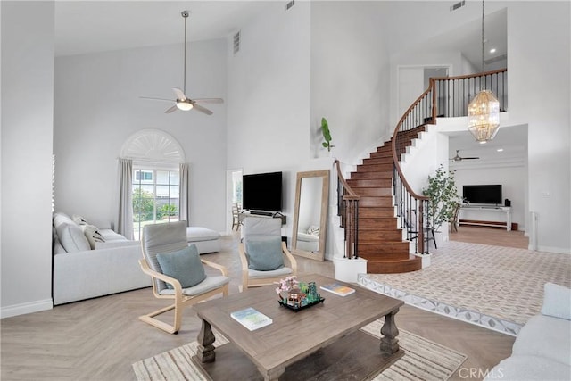 1048 Gladstone St, La Verne, CA 91750 - living room featuring a ceiling fan, a high ceiling, stairs, and baseboards